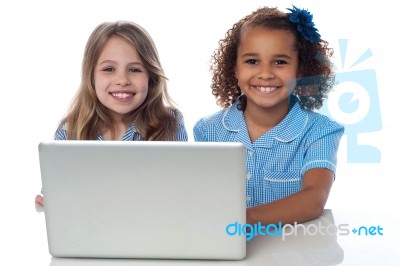 Two Cute Little School Girls With Laptop Stock Photo