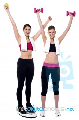 Two Smiling Girls Working Out Together Stock Photo