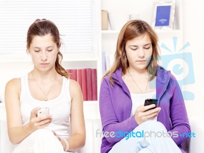 Two Teenage Girs With Mobile Phones Stock Photo