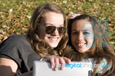 Two Women And Tablet Pc Stock Photo