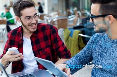 Two Young Entrepreneurs Working At Coffee Shop Stock Photo
