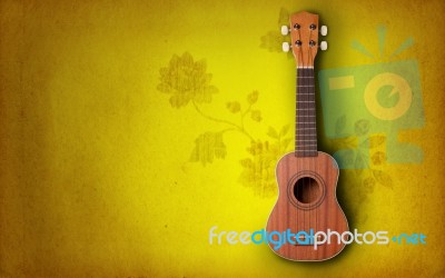 Ukulele On Yellow Background Stock Photo