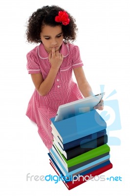 Unsure School Kid Using Tablet Pc Stock Photo