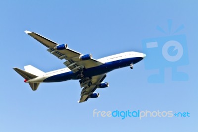 White Air Plane Flying In The Sky Stock Photo