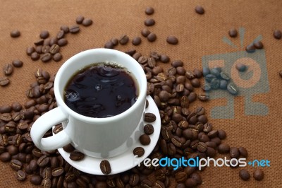White Coffee Cup And Coffee Beans Stock Photo