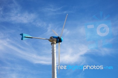 Wind Energy Turbine On Blue Sky Background Stock Photo