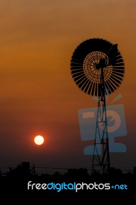 Wind Turbine In Sunset Stock Photo