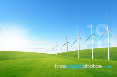 Wind Turbine On Green Grass Field Stock Photo