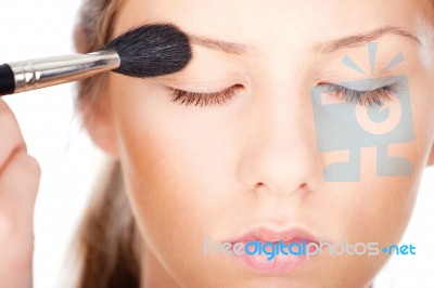 Woman Applying Make Up With Brush Stock Photo