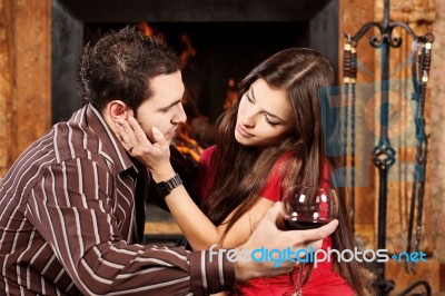 Woman Caress Her Man Near Fireplace Stock Photo