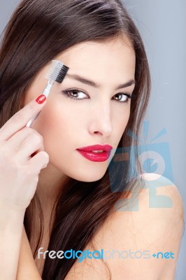 Woman Combing Eyebrow Stock Photo