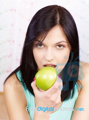 Woman Eating Green Apple Stock Photo