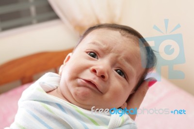 Woman Holding A Beautiful Sweet Hispanic Newborn Crying Stock Photo