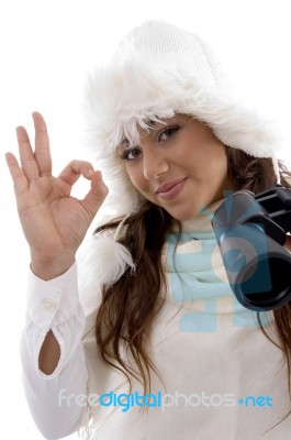 Woman Holding Binocular And Showing Okay Hand Gesture Stock Photo