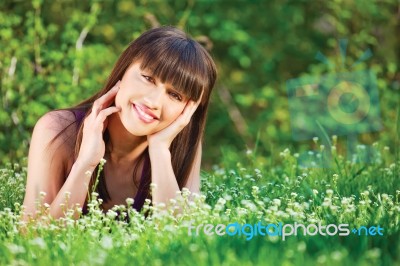 Woman Laying On Grass Stock Photo