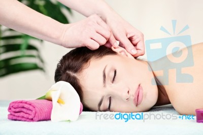 Woman On Ear Massage In Salon Stock Photo