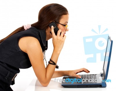 Woman On Phone And Computer Stock Photo