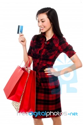 Woman Posing With Shopping Bags And Debit Card Stock Photo