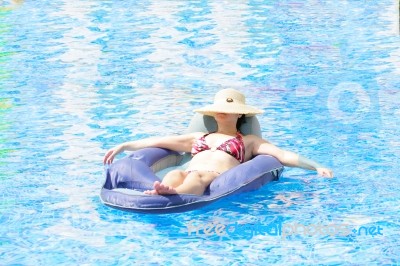 Woman Resting In Pool Stock Photo