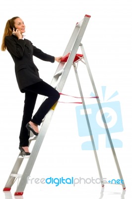 Woman Standing On Ladder Stock Photo