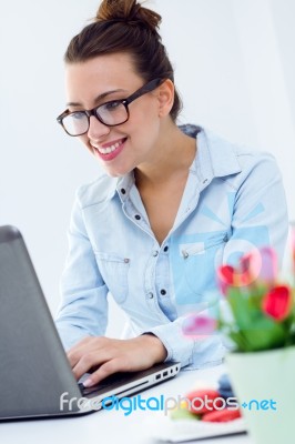 Woman With Laptop Working At Home Stock Photo