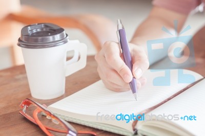 Woman Writing On Notepaper Stock Photo