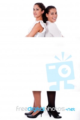 Women Standing Back To Back Stock Photo