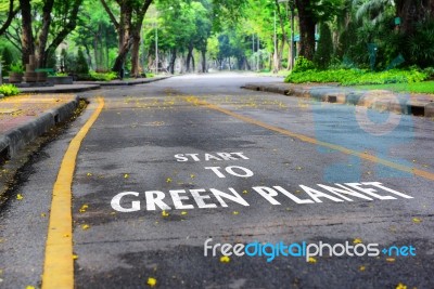 Words Of Start To Green Planet On The Road Surface Stock Photo