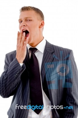 Yawning Young Businessman Stock Photo