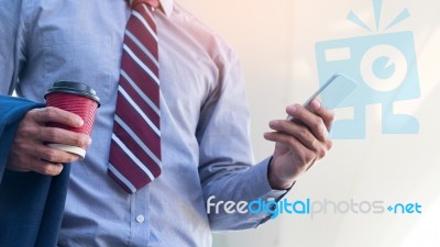 Young And Successful Businessman Is Reading A Message On His Sma… Stock Photo