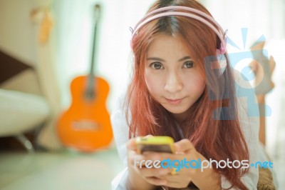 Young Asian Woman Listening To Music Stock Photo