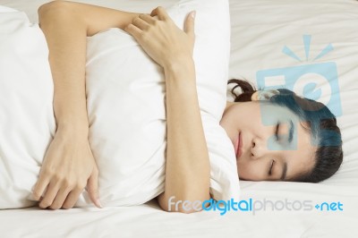 Young Beautiful Woman Sleeping In Bed Stock Photo