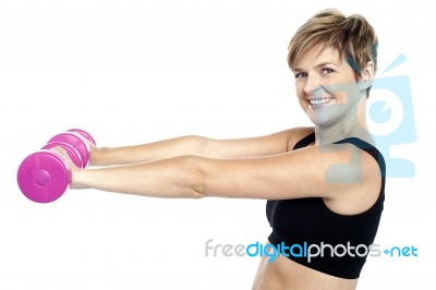 Young Beautiful Woman With Dumbbells In Hands Stock Photo