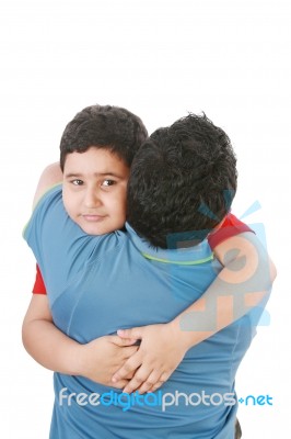 Young Boy Hugging His Father Stock Photo