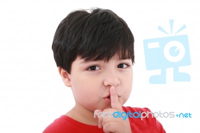 Young Boy Shows Silence Symbol Stock Photo