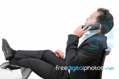Young Business Man Relaxing At Office Desk And Talking On Mobile… Stock Photo