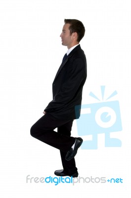 Young Businessman Benting One Leg Stock Photo