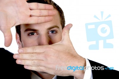 Young Businessman Making A Finger Frame In Front Of His Eyes Stock Photo