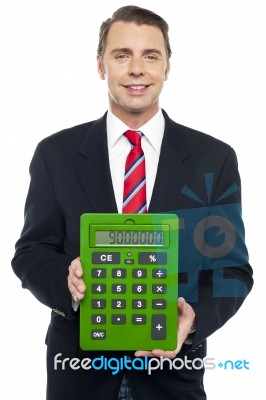 Young Businessman Showing Big Green Calculator Stock Photo