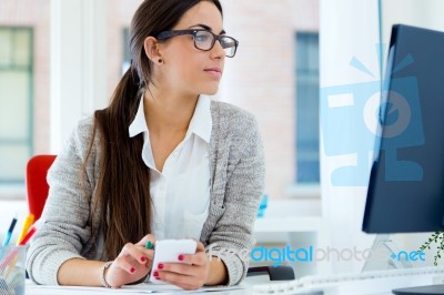 Young Businesswoman Working In Her Office With Laptop Stock Photo