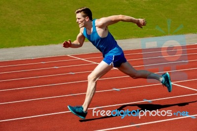 Young Caucasian Athlete Sprinting On Track Stock Photo