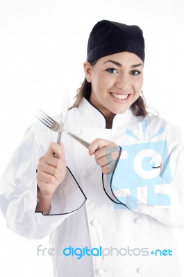 Young Chef Holding Cutlery Stock Photo