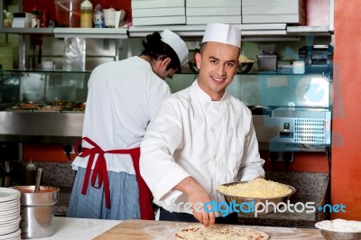 Young Chef Making Pizza At Kitchen Stock Photo