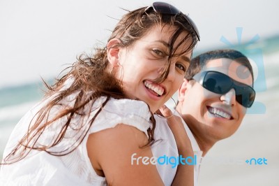 Young Couple Playing On Beach Stock Photo