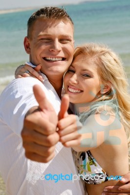 Young Couple Showing Thumbs Up Stock Photo