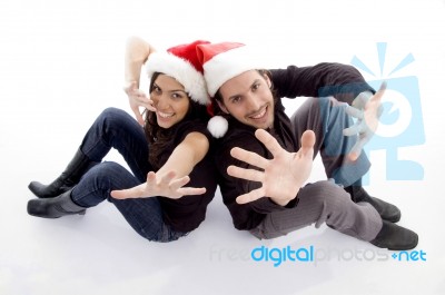 Young Couple Wearing Christmas Hat With Hand Gesture Stock Photo