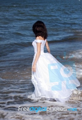 Young Girl In White Dress On The Seashore Stock Photo