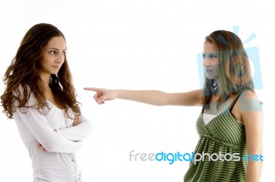 Young Girl Pointing At Her Friend Stock Photo