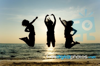 Young Girls Jumping at beach Stock Photo