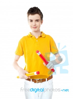 Young Kid Holding Two Big Colorful Pencils Stock Photo